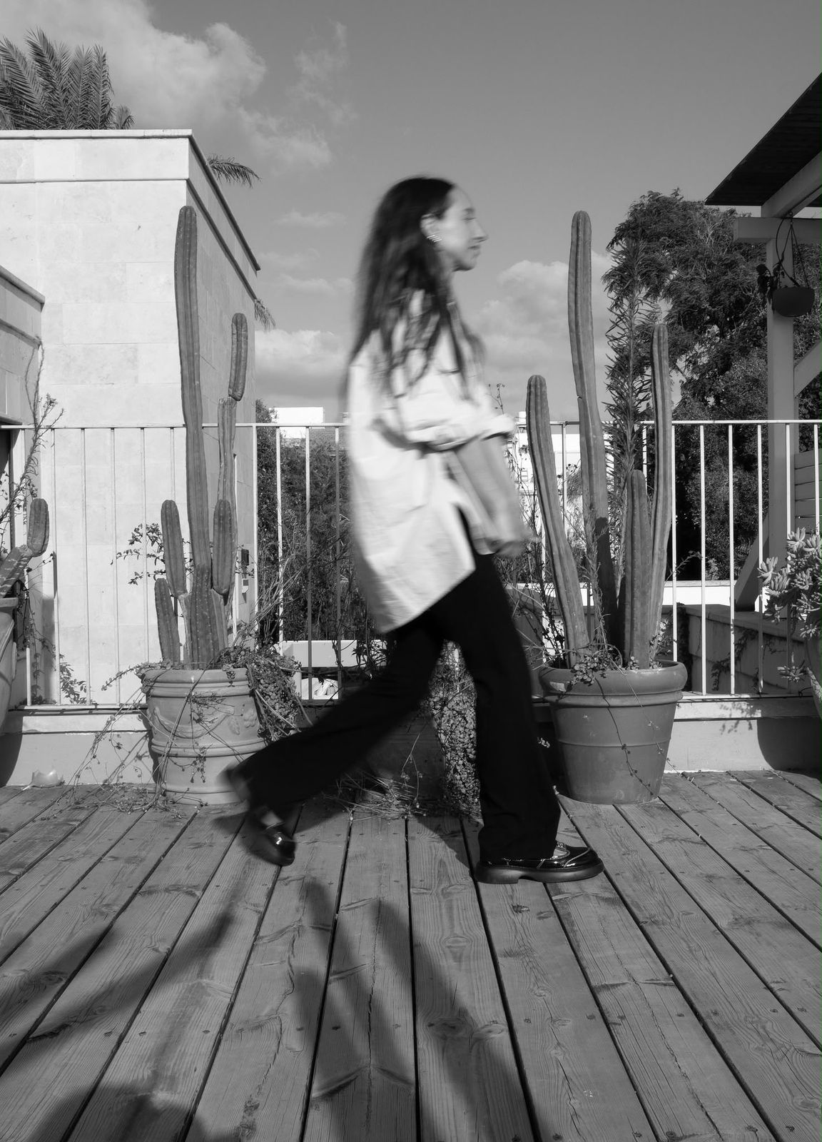 Adina Schon, naturopath, walking across a rooftop garden